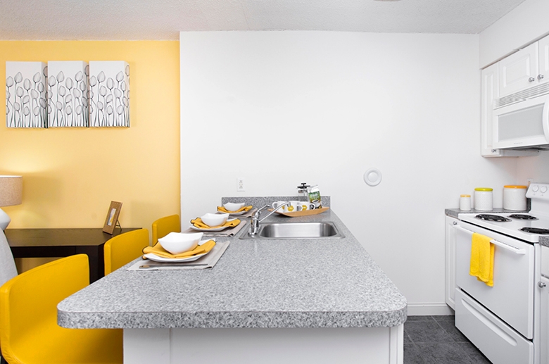 Kitchen island with sink at Barringer Residences