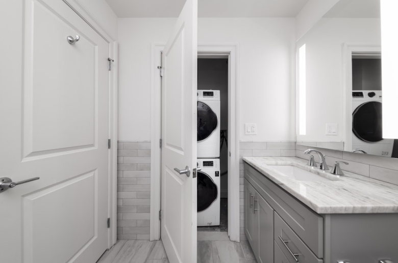 Bathroom with stackable laundry unit