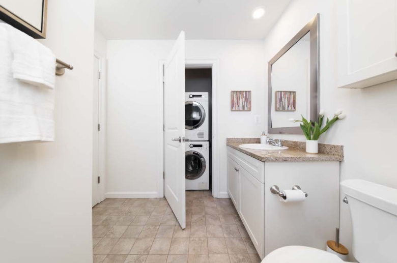 Updated modern bathroom with stackable laundry
