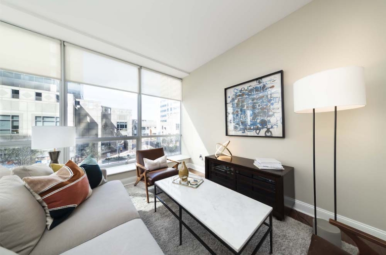 Living room with floor to ceiling windows and custom shades