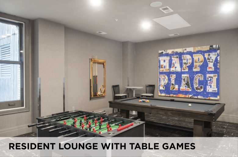 A resident lounge with table games at Eight West Third Apartments
