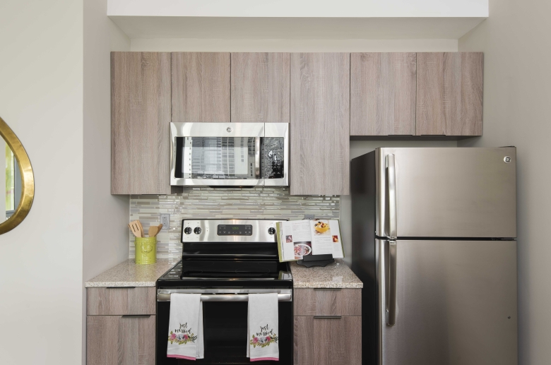 Kitchen featuring modern tile backsplash