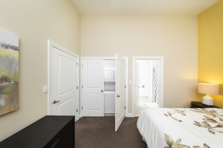 Bedroom closet with stackable washer and dryer