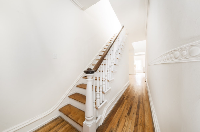 Hardwood flooring extends throughout a staircase on bi-level units