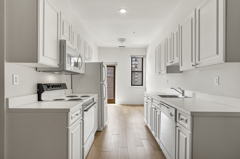 Kitchen featuring white cabinets and appliances