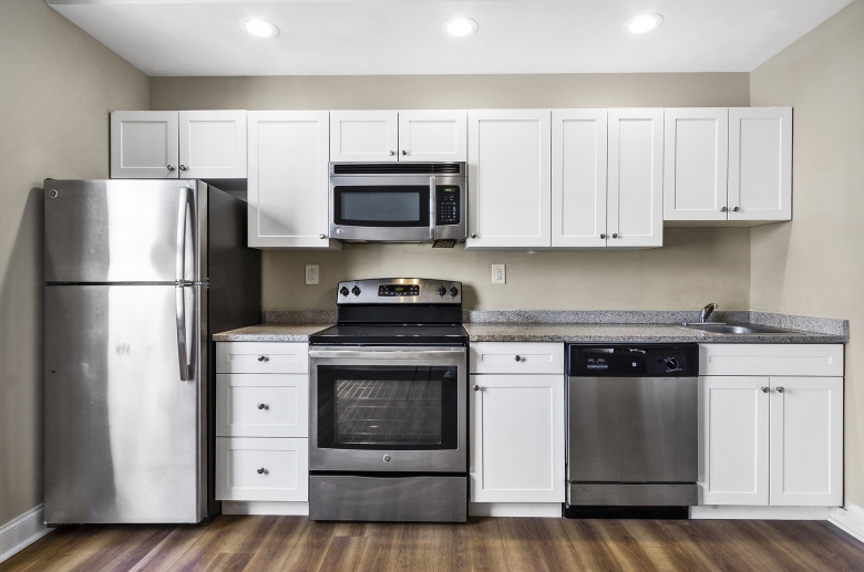 Modern kitchen with granite countertops at Adelphia House Apartments.