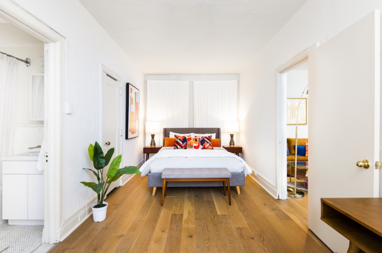 Furnished bedroom featuring hardwood flooring