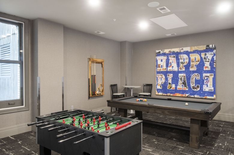 Resident lounge with pool table and foosball 