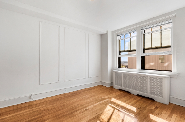 Bright sunny bedroom with hardwood flooring