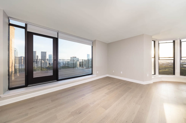 Floor to ceiling windows with custom shades connect indoor and outdoor spaces