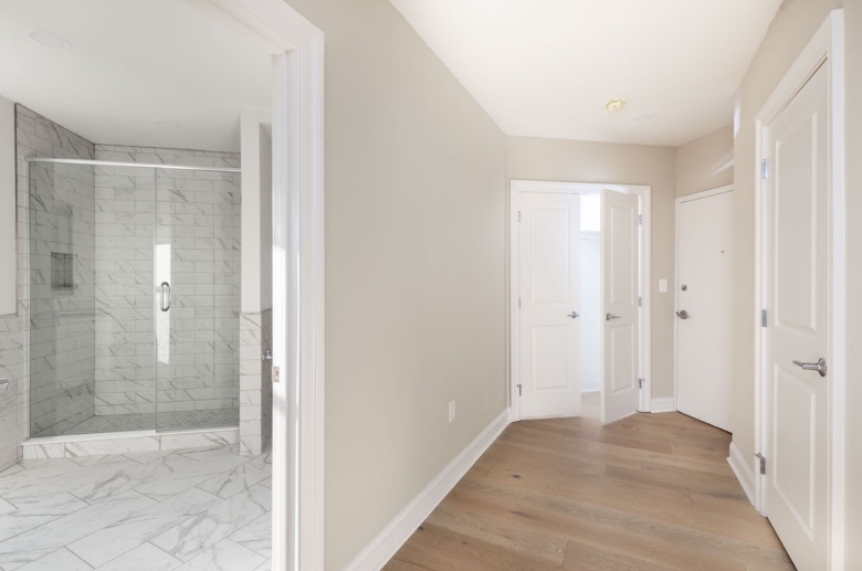 Hallway and adjacent upgraded bathroom