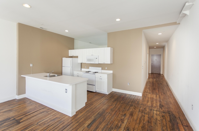 A view of the kitchen and hallway to the other rooms