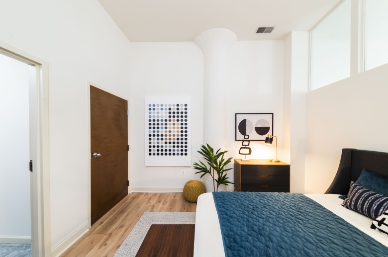Bedroom with hardwood flooring at Warehouse Apartments
