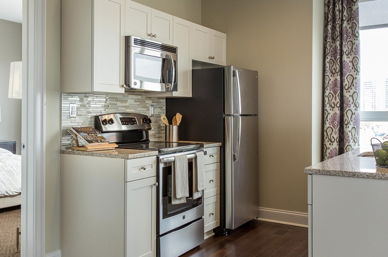 One Water Street kitchen featuring stainless steel appliances and granite countertops.