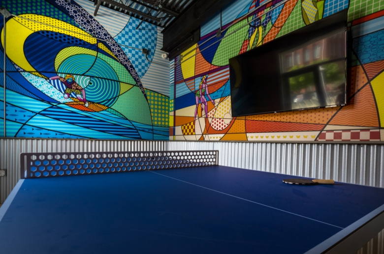 A ping pong table with big screen television