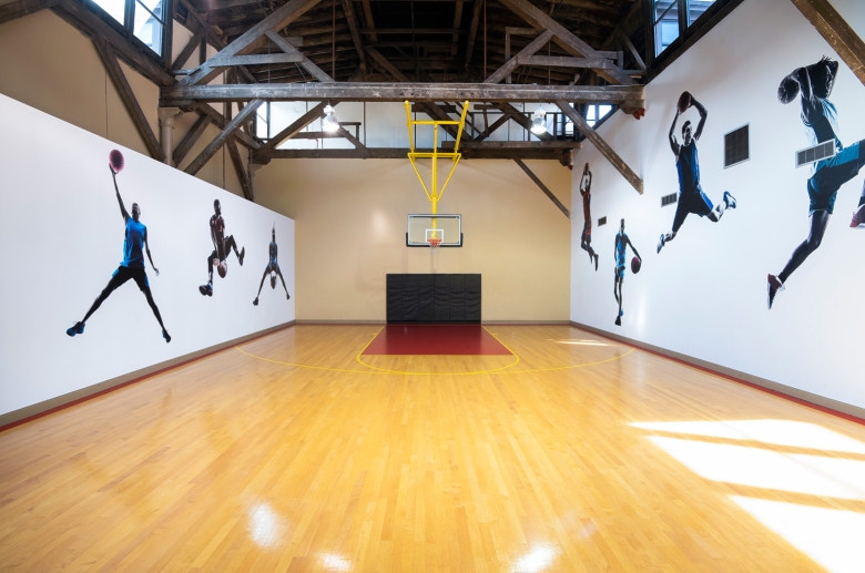 interior of gym with decorations of basketball players