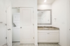 Updated modern bathroom with stackable washer and dryer