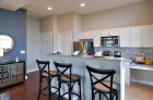 Kitchen and dining space with hardwood flooring