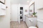 Updated modern bathroom with stackable laundry