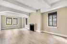 Living room with ceiling beams and working fireplace