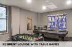 A resident lounge with table games at Eight West Third Apartments