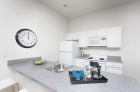 Equipped kitchen with dishwasher, refrigerator, and microwave