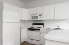 Modern kitchens with white appliances and cabinets at Society Hill Building