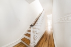 Hardwood flooring extends throughout a staircase on bi-level units