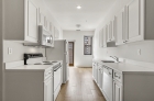 Kitchen featuring white cabinets and appliances