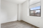 White walls contrasting hardwood floors at 1300 Chestnut Street