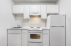 Classic white cabinets and appliances kitchen at Adelphia House