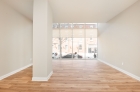 Living room with column and windows looking out onto Market Street in Philadelphia