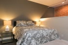 Greenehouse bedroom with exposed brick detailing