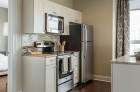 One Water Street kitchen featuring stainless steel appliances and granite countertops.