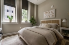 Furnished bedroom with oversized windows